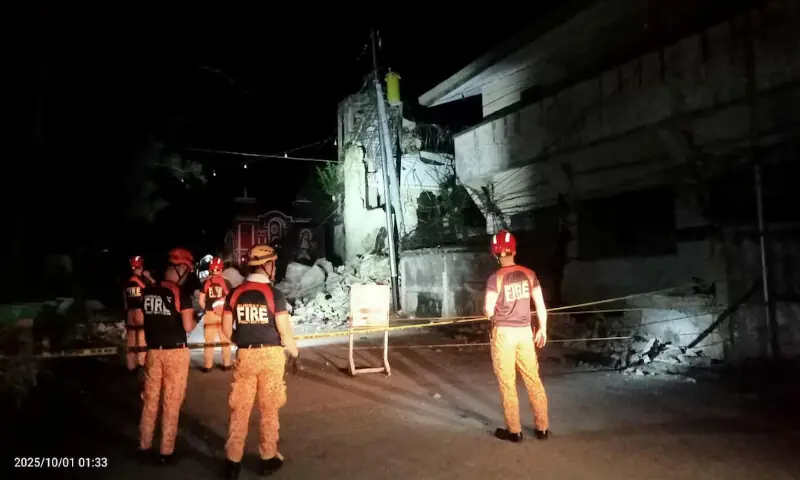 Rescue personnel stand in front of a damaged structure following a 6.9-magnitude earthquake in Daanbantayan, Cebu Province, Philippines, on Wednesday. – Reuters Rescue personnel stand in front of a damaged structure following a 6.9-magnitude earthquake in Daanbantayan, Cebu Province, Philippines, on Wednesday. – Reuters
