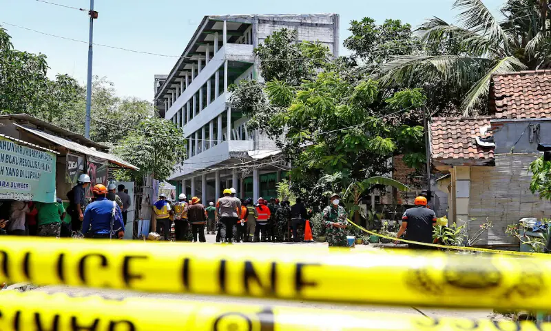 Rescuers gather near the site of a building collapse in Sidoarjo, East Java province, Indonesia, on Thursday. – Reuters Rescuers gather near the site of a building collapse in Sidoarjo, East Java province, Indonesia, on Thursday. – Reuters