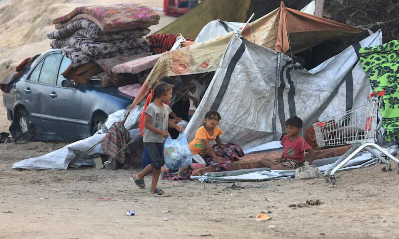 Displaced Palestinians sit next to a tent, after Hamas agreed to accept some other terms in a US peace plan, in the central Gaza Strip on Saturday. – Reuters Displaced Palestinians sit next to a tent, after Hamas agreed to accept some other terms in a US peace plan, in the central Gaza Strip on Saturday. – Reuters