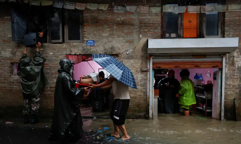 Members of the Nepal Army help people retrieve their belongings to a safe area following heavy rains in Kathmandu. – Reuters Members of the Nepal Army help people retrieve their belongings to a safe area following heavy rains in Kathmandu. – Reuters