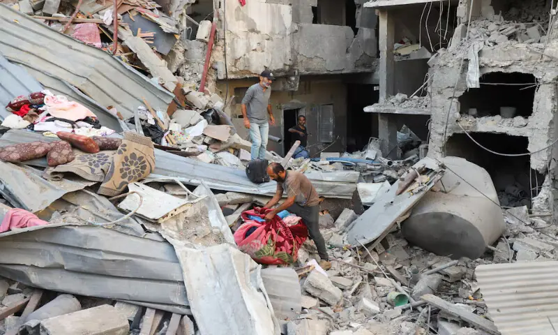 Palestinians inspect the site of an Israeli strike on a house in the Tuffah neighbourhood in Gaza City on Sunday. – Reuters Palestinians inspect the site of an Israeli strike on a house in the Tuffah neighbourhood in Gaza City on Sunday. – Reuters