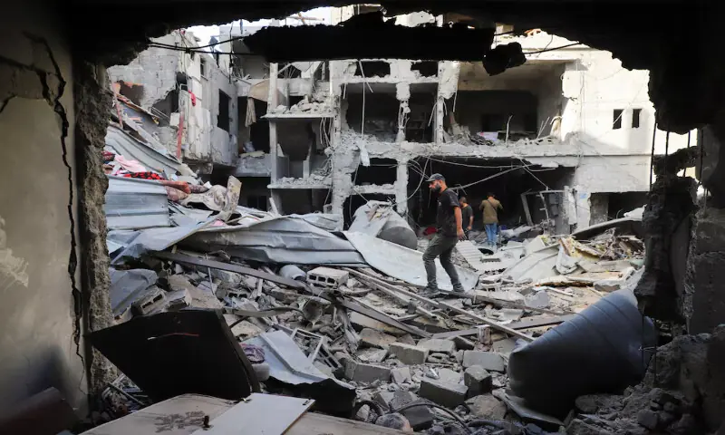 Palestinians inspect the site of an Israeli strike on a house in the Tuffah neighbourhood in Gaza City on Sunday. – Reuters Palestinians inspect the site of an Israeli strike on a house in the Tuffah neighbourhood in Gaza City on Sunday. – Reuters