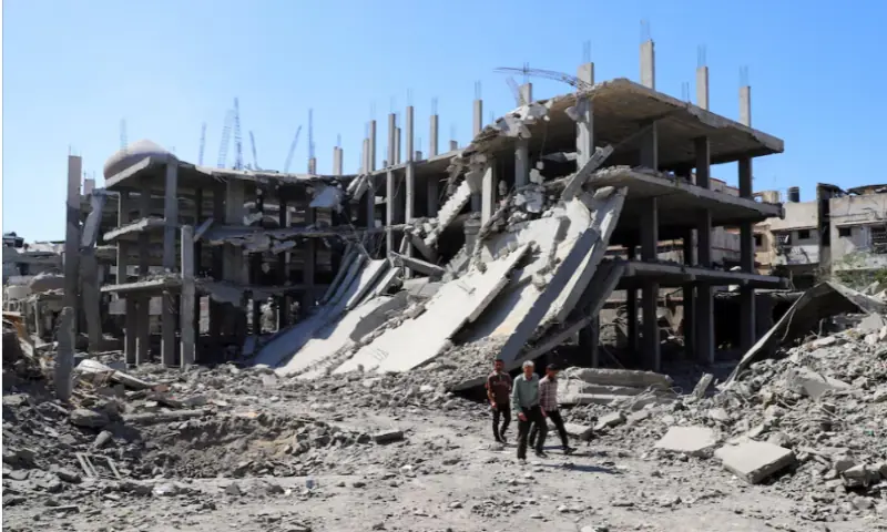 Palestinians walk past a destroyed building, as they inspect the damage in the aftermath of an Israeli operation at the Sabra neighbourhood in Gaza City, on October 8, 2025. Reuters Palestinians walk past a destroyed building, as they inspect the damage in the aftermath of an Israeli operation at the Sabra neighbourhood in Gaza City, on October 8, 2025. Reuters