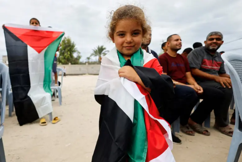 A girl holds a Palestinian flag, after Israel and Hamas agreed on the first phase of a Gaza ceasefire, in the central Gaza Strip, on October 9. Reuters A girl holds a Palestinian flag, after Israel and Hamas agreed on the first phase of a Gaza ceasefire, in the central Gaza Strip, on October 9. Reuters