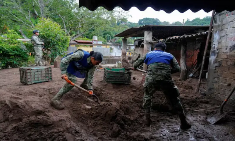 Members of the Mexican navy remove mud from the courtyard of a house as torrential rains from tropical storm Raymond triggered landslides and flooding in Jalcocotan, Nayarit state, Mexico, on October 12, 2025. Reuters Members of the Mexican navy remove mud from the courtyard of a house as torrential rains from tropical storm Raymond triggered landslides and flooding in Jalcocotan, Nayarit state, Mexico, on October 12, 2025. Reuters