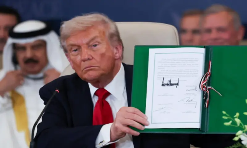 Trump holds the signed agreement in Sharm el-Sheikh, Egypt, on October 13, 2025. Reuters