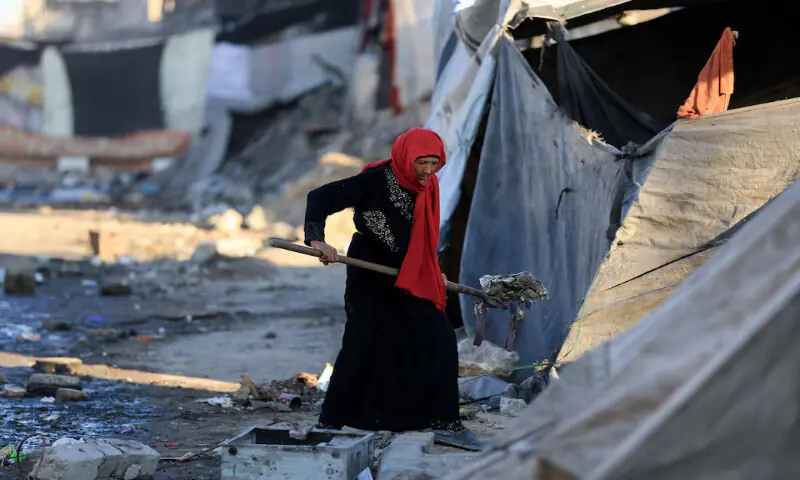 A Palestinian woman cleans an area next to tents in Gaza City on Tuesday. – Reuters A Palestinian woman cleans an area next to tents in Gaza City on Tuesday. – Reuters