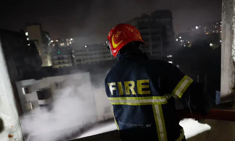 A firefighter sprays water from a multi-storey building to douse the fire that broke out at a garment factory and a chemical warehouse in Dhaka, Bangladesh, on Tuesday. – Reuters A firefighter sprays water from a multi-storey building to douse the fire that broke out at a garment factory and a chemical warehouse in Dhaka, Bangladesh, on Tuesday. – Reuters
