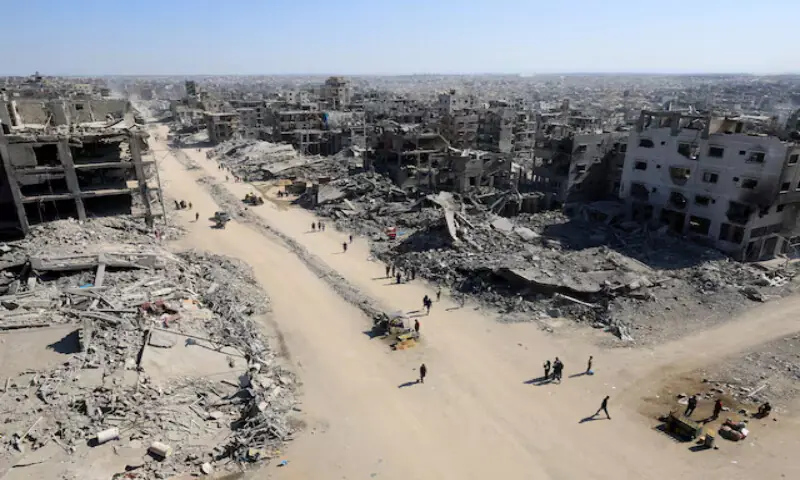 Palestinians walk past the rubble of buildings destroyed in Israeli strikes in Gaza City on Thursday. – Reuterts Palestinians walk past the rubble of buildings destroyed in Israeli strikes in Gaza City on Thursday. – Reuterts