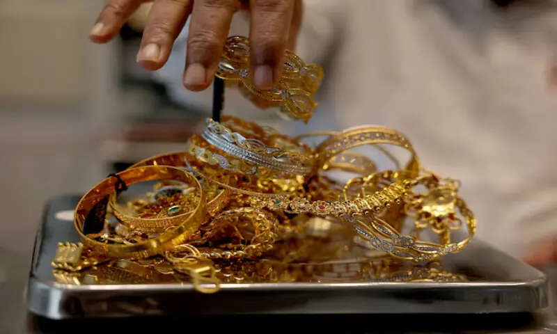 A goldsmith weighs gold jewellery inside a showroom in Ahmedabad, India. – Reuters file A goldsmith weighs gold jewellery inside a showroom in Ahmedabad, India. – Reuters file