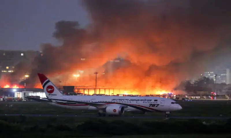 A passenger plane sits on the tarmac, as smoke rises from a fire, which broke out in the cargo bay of the Hazrat Shahjalal International Airport, in Dhaka, Bangladesh. – Reuters A passenger plane sits on the tarmac, as smoke rises from a fire, which broke out in the cargo bay of the Hazrat Shahjalal International Airport, in Dhaka, Bangladesh. – Reuters