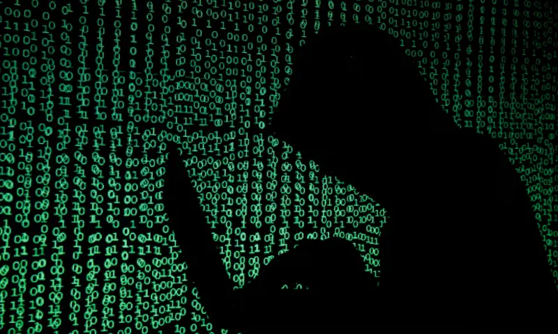A hooded man holds a laptop computer as cyber code is projected on him in this illustration picture taken on May 13, 2017//REUTERS A hooded man holds a laptop computer as cyber code is projected on him in this illustration picture taken on May 13, 2017//REUTERS