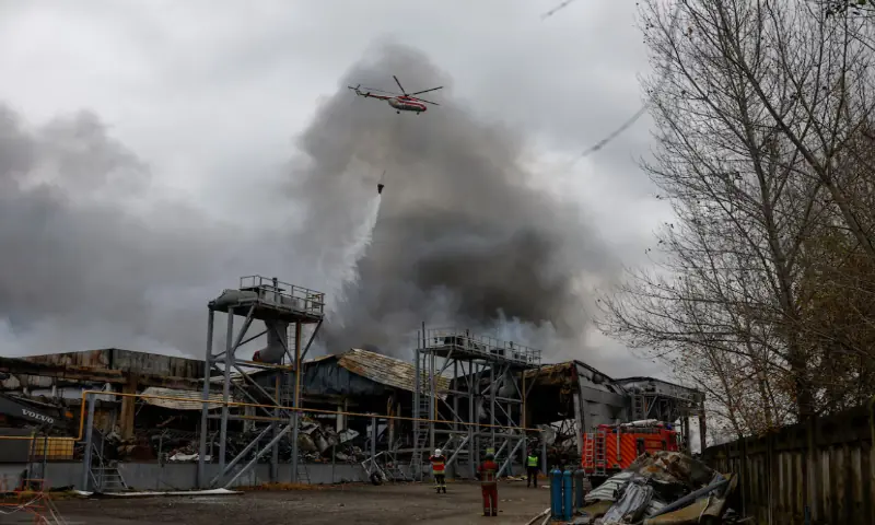 A firefighting helicopter drops water over food warehouses hit by an overnight Russian missile strike, amid Russia’s attack on Ukraine, in Kyiv, Ukraine, October 25, 2025//REUTERS