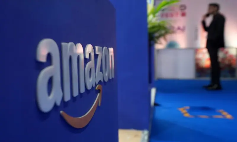 A visitor stands near a logo of Amazon during the annual Retail Leadership Summit in Mumbai, India, February 27, 2025//REUTERS A visitor stands near a logo of Amazon during the annual Retail Leadership Summit in Mumbai, India, February 27, 2025//REUTERS