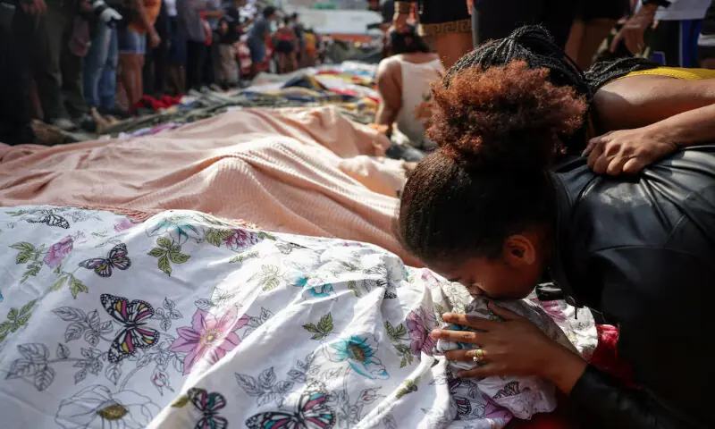 A mourner kisses a covered body in Rio de Janeiro. – Reuters A mourner kisses a covered body in Rio de Janeiro. – Reuters