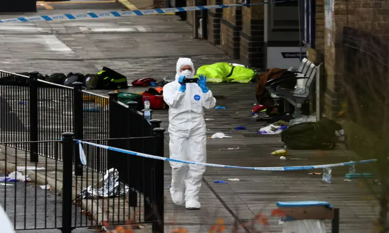 A forensic officer works at the scene at Huntingdon Station following stabbings on a train near Cambridge, Britain, on Sunday. – Reuters