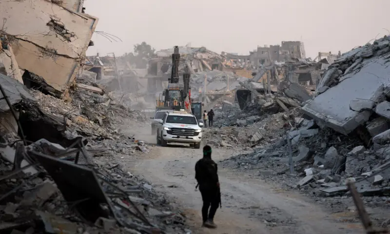 Red Cross vehicles drive, after Hamas said that it found the body of an Israeli hostage soldier on Tuesday and prepared to return it to Israel through the Red Cross, in Gaza City//REUTERS Red Cross vehicles drive, after Hamas said that it found the body of an Israeli hostage soldier on Tuesday and prepared to return it to Israel through the Red Cross, in Gaza City//REUTERS