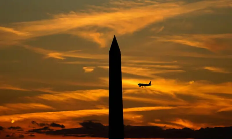 A commercial aircraft flies past the Washington Monument during a partial government shutdown in Washington, DC., US, October 2, 2025//REUTERS A commercial aircraft flies past the Washington Monument during a partial government shutdown in Washington, DC., US, October 2, 2025//REUTERS
