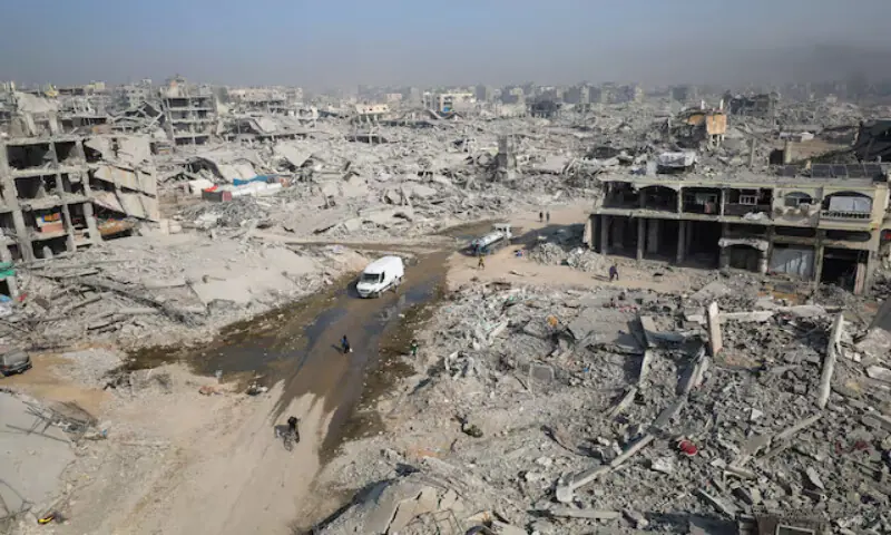 Palestinians walk past the rubble of destroyed buildings in Gaza City. – Reuters Palestinians walk past the rubble of destroyed buildings in Gaza City. – Reuters