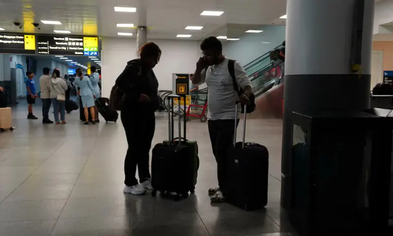 Travellers use a mobile phone at Terminal 8 at John F. Kennedy International Airport in New York, US, June 8, 2025//REUTERS Travellers use a mobile phone at Terminal 8 at John F. Kennedy International Airport in New York, US, June 8, 2025//REUTERS