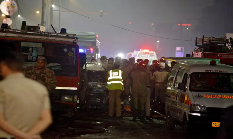 Police and firefighters stand guard at the site of an explosion in the old quarters of Delhi, India. – Reuters
