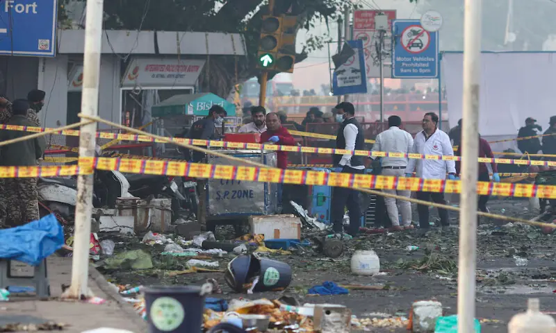 Security personnel and members of the forensic team work at the site of an explosion near Red Fort in the old quarters of Delhi, India. – Reuters