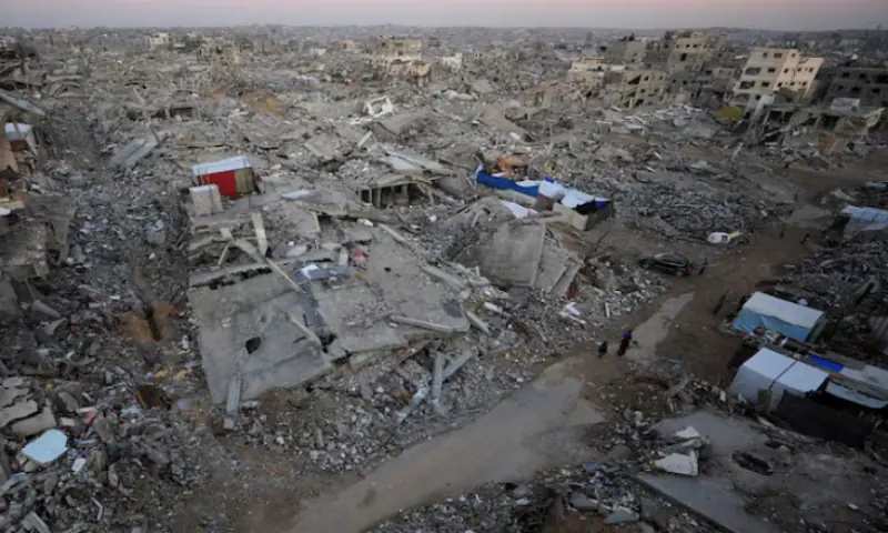 Palestinians stand near rubble from destroyed buildings, amid a ceasefire between Israel and Hamas, in Gaza City, November 17, 2025//REUTERS Palestinians stand near rubble from destroyed buildings, amid a ceasefire between Israel and Hamas, in Gaza City, November 17, 2025//REUTERS