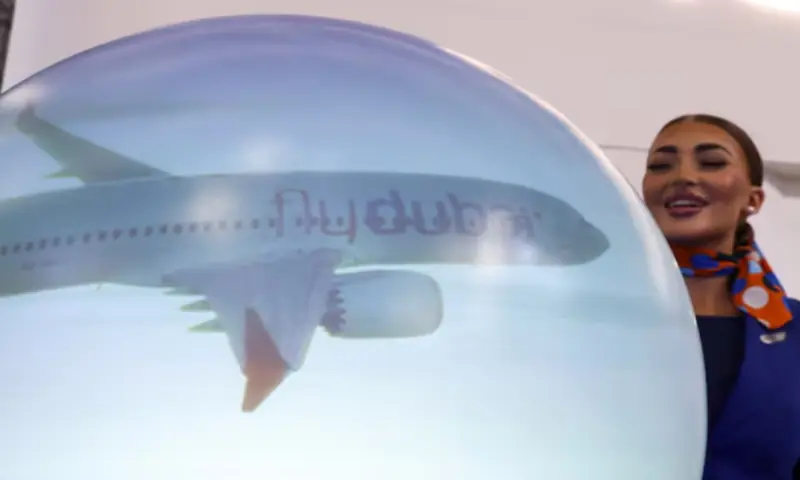 A staff member stands near a ‘flydubai’ display at the Dubai Airshow, in Dubai, on November 17, 2025. Reuters