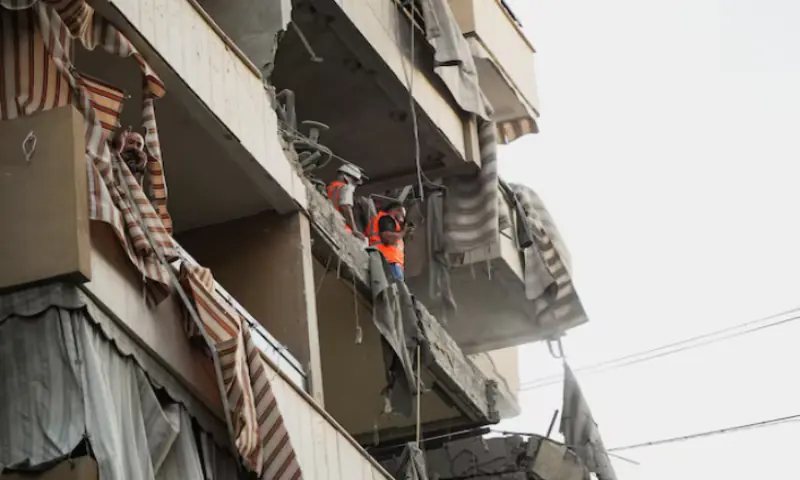 People inspect a damaged building, after Israeli military said on Sunday that it struck a militant from the Lebanese Iran-aligned Hezbollah group, in Beirut’s southern suburbs, Lebanon, November 23, 2025//REUTERS