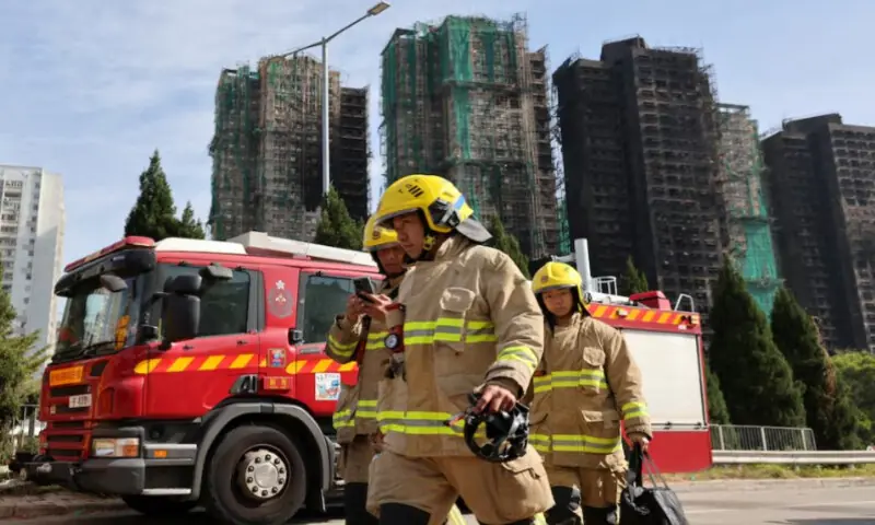 Firefighters walk near the site of a major fire at Wang Fuk Court housing complex, where flames engulfed bamboo scaffolding across multiple blocks, in Tai Po, Hong Kong. Reuters