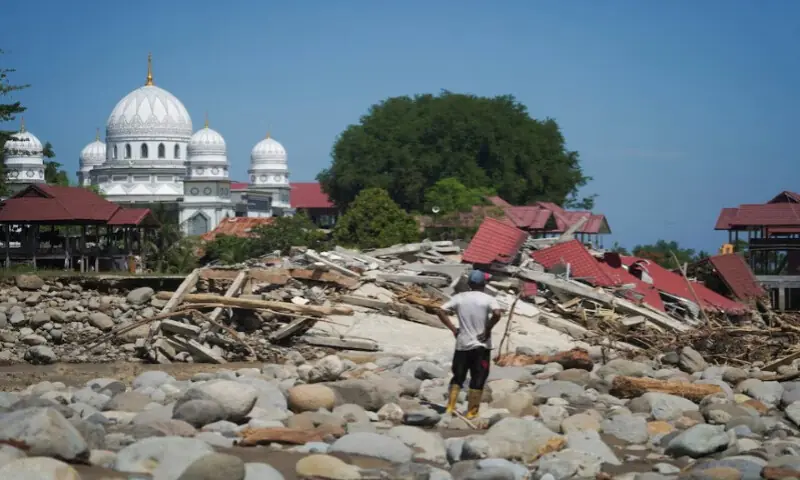 A resident stands near debris as he inspects an area hit by deadly flash floods following heavy rains in Pidie Jaya, Aceh, Indonesia, on November 29, 2025. Reuters