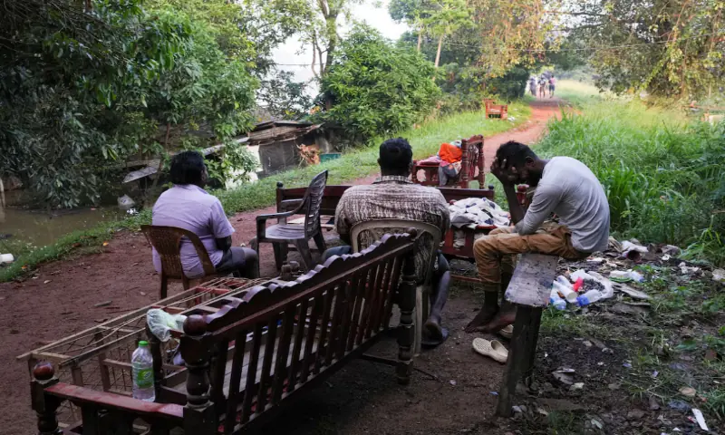 People sit next to furnitures salvaged from a flooded house along the banks of Kelani River, following Cyclone Ditwah in Peliyagoda, Sri Lanka, December 1, 2025. — Reuters.