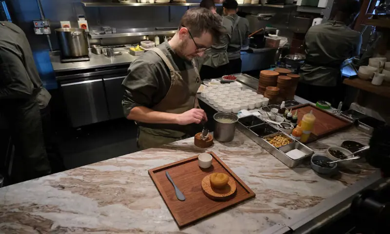 A chef prepares Cornish potatoes, toasted hazelnuts, sweet & sour apricots, a vegan dish on the menu at Plates restaurant in London. – Reuters