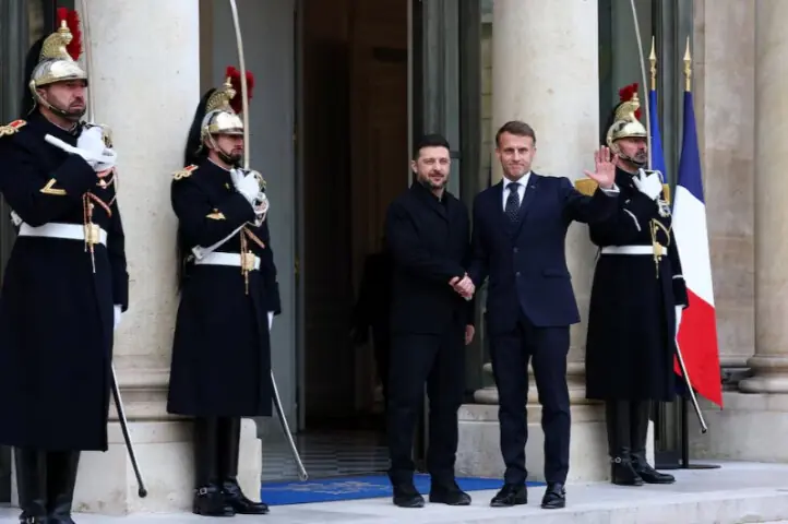 French President Emmanuel Macron shakes hands with Ukrainian President Volodymyr Zelensky as he arrives for a meeting at the Elysee Palace in Paris, France, December 1, 2025. Reuters
