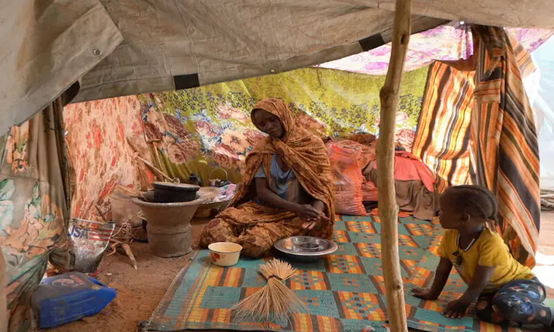 Awadeya, a Sudanese displaced woman who was held by the paramilitary Rapid Support Forces, cooks food at a camp for displaced people. – Reuters