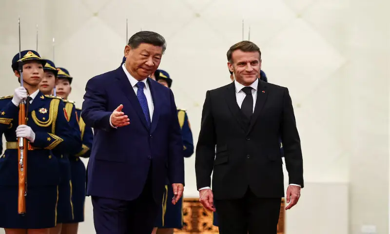 Chinese President Xi Jinping gestures next to French President Macron during an official welcome ceremony at the Great Hall of the People in Beijing on Thursday. – Reuters