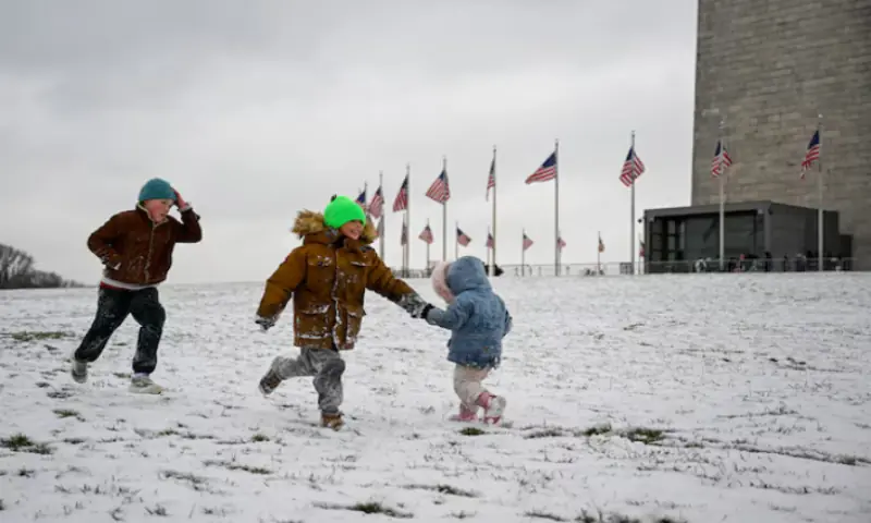 Gabriel Tritt, 9, Mads Lichtwerch, 6, and Saga Lichtwerch, 2, run in the snow near the Washington Monument after the first snow of the winter season, in Washington, D.C., U.S., December 5, 2025. —Reuters