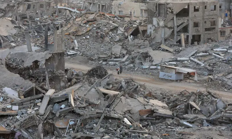 Palestinian women walk among piles of rubble and damaged buildings, in Gaza City, November 24, 2025. REUTERS Palestinian women walk among piles of rubble and damaged buildings, in Gaza City, November 24, 2025. REUTERS