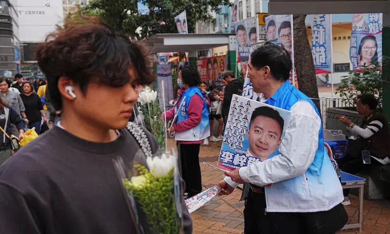 Supporters of New People’s Party candidate Dominic Lee distribute campaign leaflets during the Legislative Council general election, in Hong Kong, China, on Sunday. – Reuters