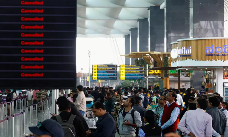 Travellers look at updates on flights, as they stand next to a screen displaying details of cancelled IndiGo Airlines flights, at Kempegowda International Airport in Bengaluru, India, December 6, 2025. —Reuters Travellers look at updates on flights, as they stand next to a screen displaying details of cancelled IndiGo Airlines flights, at Kempegowda International Airport in Bengaluru, India, December 6, 2025. —Reuters