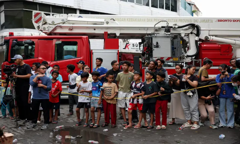 People watch a seven-storey building damaged by fire, in Jakarta, Indonesia, December 9, 2025. —Reuters People watch a seven-storey building damaged by fire, in Jakarta, Indonesia, December 9, 2025. —Reuters