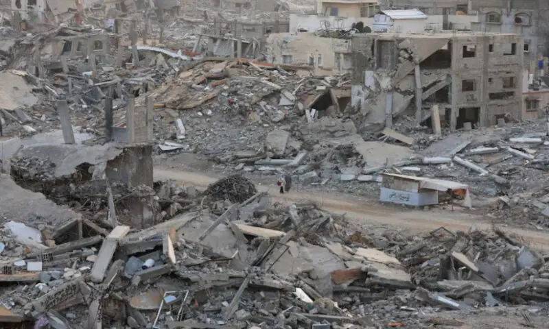 Palestinian women walk among piles of rubble and damaged buildings in Gaza City, on November 24, 2025. Reuters file Palestinian women walk among piles of rubble and damaged buildings in Gaza City, on November 24, 2025. Reuters file