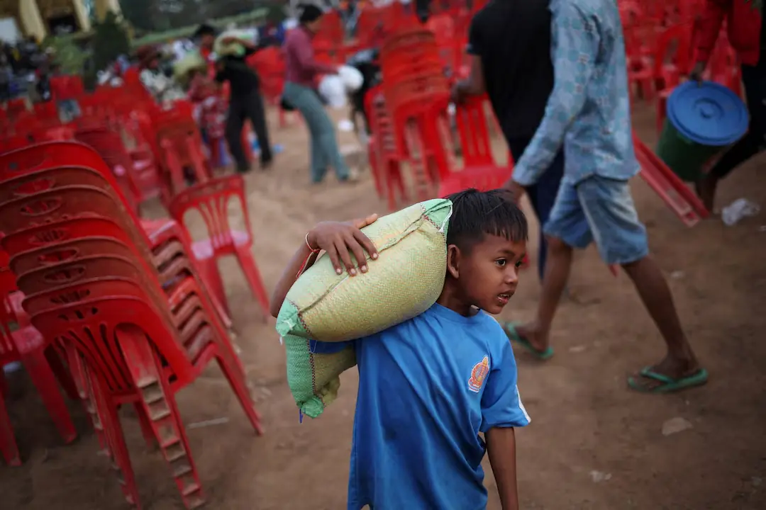 A boy carries a sack of rice given as aid at Batthkav refugee camp, amid clashes between Thailand and Cambodia - Reuters A boy carries a sack of rice given as aid at Batthkav refugee camp, amid clashes between Thailand and Cambodia - Reuters