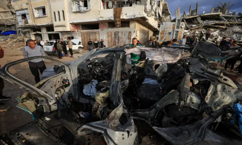 Palestinians inspect the site of an Israeli strike on a car in Gaza City, on December 13, 2025. Reuters Palestinians inspect the site of an Israeli strike on a car in Gaza City, on December 13, 2025. Reuters