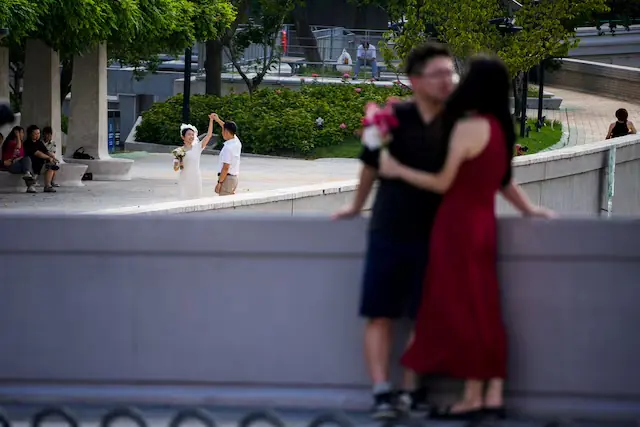 Couples prepare to get their photo taken during a wedding photography shoot on a street in Shanghai, China, September 6, 2023. – Reuters Couples prepare to get their photo taken during a wedding photography shoot on a street in Shanghai, China, September 6, 2023. – Reuters