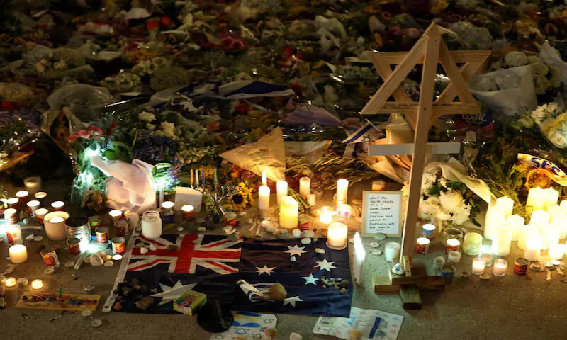An Australian flag sits among floral tributes honouring the victims of the Bondi Beach shooting in Sydney, Australia. – Reuters An Australian flag sits among floral tributes honouring the victims of the Bondi Beach shooting in Sydney, Australia. – Reuters