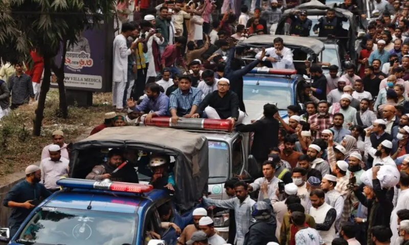A convoy carrying the body of Sharif Osman Hadi, a student leader, who died after being shot in the head, moves along the crowd after the funeral prayer, in Dhaka, Bangladesh, on December 20, 2025. Reuters