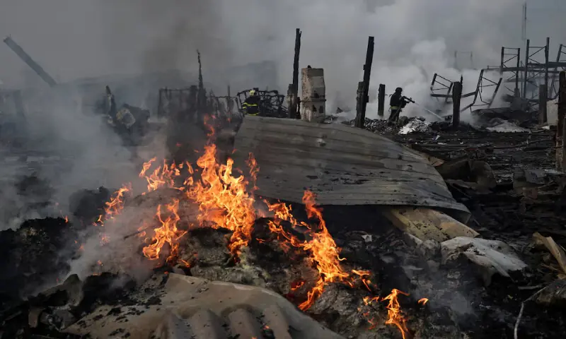 Emergency responders work at the site of a warehouse that was struck during a night of Russian missile and drone strikes in Novi Petrivtsi, outside Kyiv, Ukraine.&ndash; Reuters