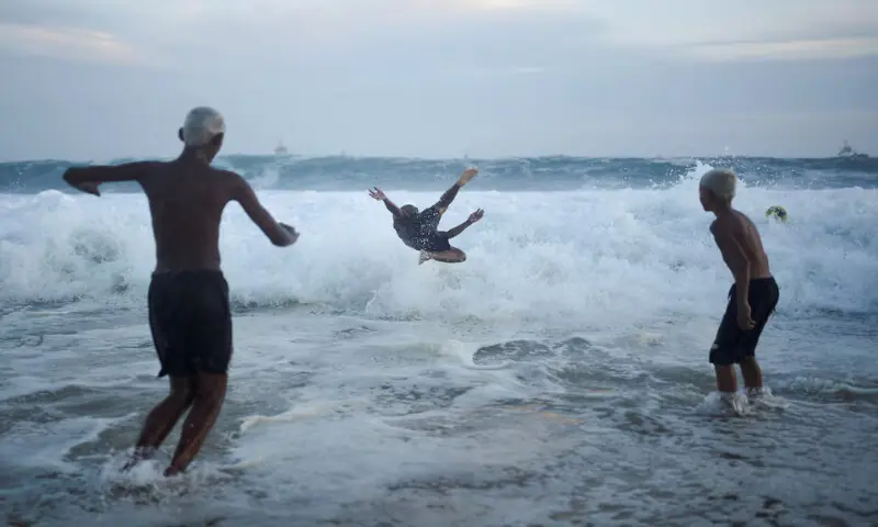 People play in the waves ahead of New Year&rsquo;s celebrations, at the Copacabana beach in Rio de Janeiro, Brazil. &ndash; Reuters