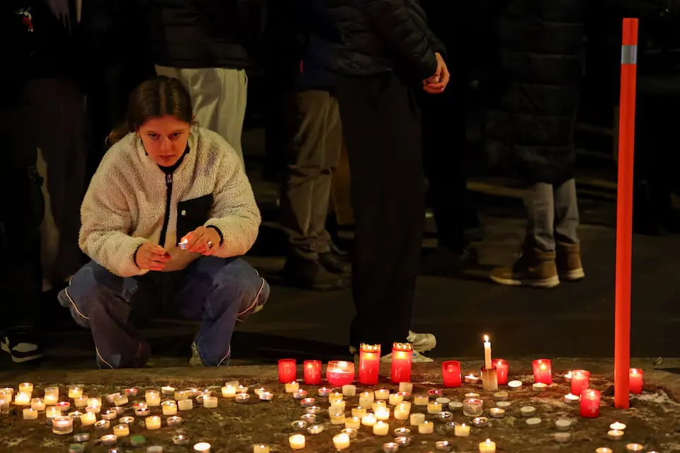 A woman holds a candle outside the &ldquo;Le Constellation&rdquo; bar, after a fire and explosion during a New Year&rsquo;s Eve party where several people died, and others were injured. &ndash; Reuters